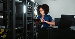 clip-3543671589-tablet-engineer-woman-on-laptop-server-room