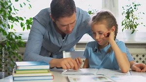 Father helping daughter with homework at home. Stock Video