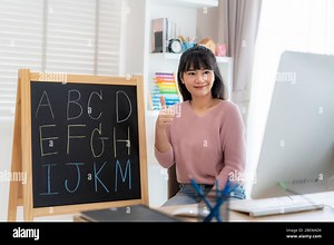 Asian woman teacher teaching English alphabet via video conference e-learning to elementary school student, Homeschooling and distance learning ,onlin Stock Photo - Alamy
