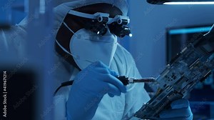 African-american microelectronics engineer works in a modern scientific laboratory on computing systems and microprocessors. Electronic factory worker is testing the motherboard and coding.
