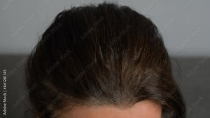 Head of an elderly woman with gray hair that grew after dyeing