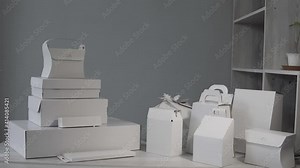 Different types of white cardboard packaging. For fast food, folding, large and small. The concept of production and design of paper products. Place for text. Selective focus. copy space