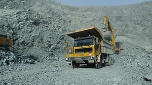 Yellow dump truck at a mining site removing rubble - Free Stock Video