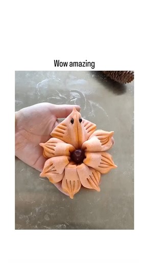 👁️ | - This X post shares a 24-second ASMR-style video tutorial demonstrating how to fold and shape orange fondant or salt dough into a delicate... | Instagram