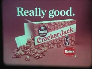 Cracker Jack is an American brand of snack consisting of molasses-flavored, caramel-coated popcorn and peanuts, well known for being packaged with a prize of trivial value inside. | Killer Cosmonaut