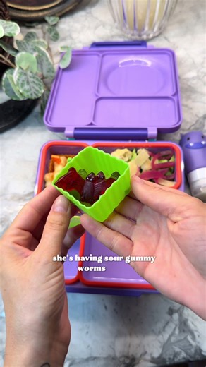 Spooky bento box lunch featuring bat-shaped gummies and Caesar salad