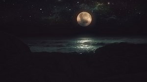 Moonlight Ocean Rocks Full Moon Glow Over Water. Full moon glow over ocean waves on a sand beach at night. Waves washing up sand beach