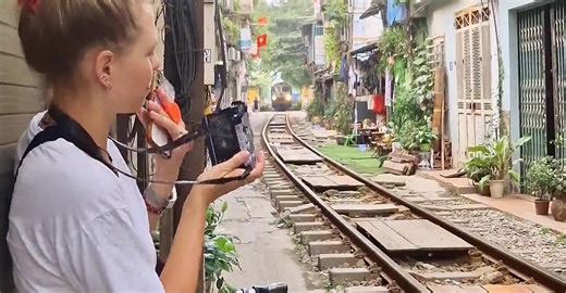 Couple Visit Hanoi's Famous Train Street