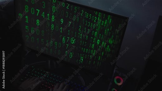 Cybersecurity Hacker Typing Green Matrix Binary Code on Monitor, Close-up of Hands Typing on RGB Keyboard with Scrolling Green Numbers