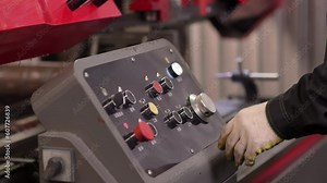 Equipment, technology, industry, electronic buttons in manufacturing control. Worker operating industrial machine in factory, Hand pressing button on panel to turn off high-tech production line