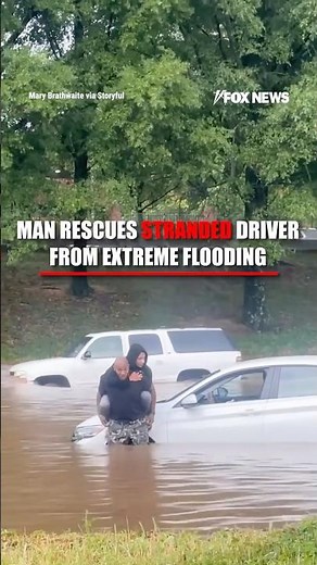 WATCH: Good Samaritan rescues woman stranded on top of her submerged car #usa #shorts #flood