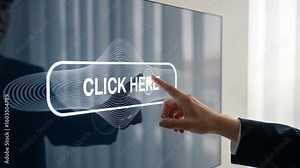 Interactive Display: Finger Taps "Click Here" Button on Modern Touchscreen Monitor in Bright Office