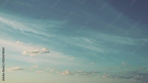 Witness a stunning retro sunset as the sky transforms into vibrant hues, highlighted by soft clouds drifting throughout. The tranquil atmosphere evokes a sense of peace and reflection. Time lapse