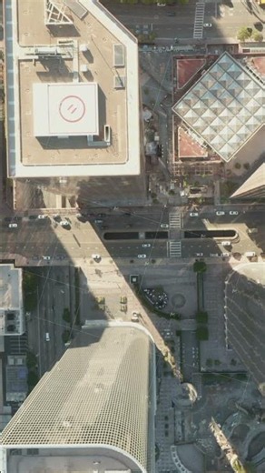 Above the rooftops of Downtown Los Angeles, California with Helicopter Pads, Wide Aerial Birds Eye