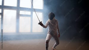 A young woman fencer showing basic attack movements on the fencing
