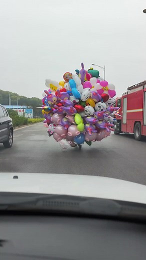 Colorful Balloons Transported by Bicycle in Urban Scene