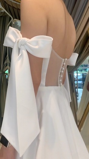 1.1K views · 49 reactions | Swooning over this dress 懶 We added bows on the shoulders and a sheer back detail on our Cathy2 dress #CouCoubyMelOrlina #melorlina #2023wedding #weddingdress #ivory #bride #minimalistbride | Mel Orlina Couture | Facebook