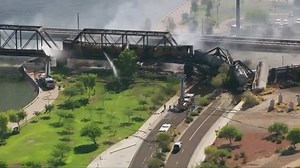 WATCH: A freight train traveling on a bridge that spans a lake in a Phoenix suburb derailed today, setting the bridge on fire and partially collapsing it: bit.ly/2P330M6 | WDBJ7