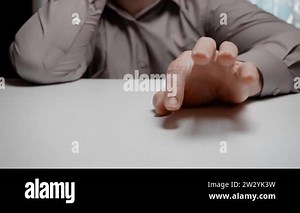 A bored clerk or businessman is tapping his fingers on the table. Hand of a man in a gray shirt is knocking on the table, close-up Stock Video Footage - Alamy