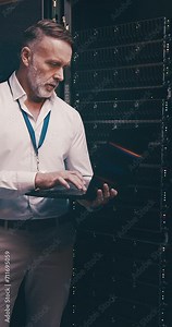 Mature man in data center with laptop, engineering or network maintenance in digital storage for database update. Tech employee, system administration and technician online in server room on computer