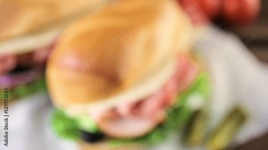 Sub sandwich with fresh vegetables, lunch meat and cheese on hoagie roll