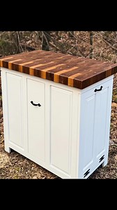 Our small handcrafted kitchen island with walnut end grain butcher block top, two tilt out trash cans, and slide out olive oil drawer is one of our most popular smaller units. #8milecraftloop #gatlinburgartsandcraftscommunity #endgrain #kitchenisland #HealthyLifestyle #familybusiness #womanwoodworker #woodworking #gatlinburgcraftsmenfair #gatlinburgcraftsmensfair #gatlinburgtennessee #gatlinburgcraft | Foxcreek Baskets & Woodworking