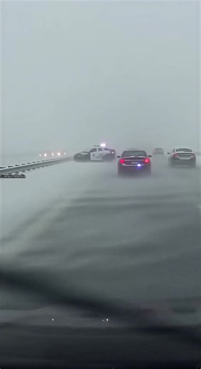 Police Cruiser Repeatedly Struck During Icy Highway Crashes 🚔 Interstate 80, Wyoming — January 6, 2024 Dashcam footage captures a dangerous scene on an icy stretch of Interstate 80 as a police cruiser sits parked on the shoulder with emergency lights flashing during a snowstorm. Blowing snow reduces visibility when a passing car hits black ice, loses control, and slides directly into the cruiser. Seconds later, another vehicle skids sideways through the storm and collides with the patrol car. M