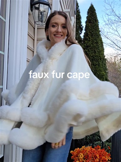 Soft faux fur with a hood that keeps you warm without wearing a full coat. Easy to throw on, comfortable indoors, and polished enough for winter get-togethers or hosting at home. #fauxfurcape #hoodedcape #winterwrap #plushouterwear #womenswinterwear @IROJEFF