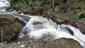 A beautiful waterfall in the middle of the mountains in the rainforest.