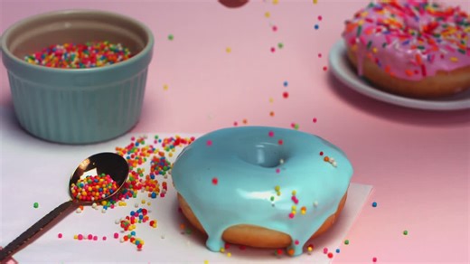 Colorful Donuts with Sprinkles on a Table - Free Stock Video