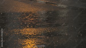 Downtown Heavy Rain, Slow Motion. A downpour on a city street at dusk filmed in slow motion.
