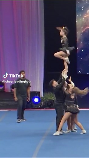 Cheerleaders Perform Synchronized Routine at Competition