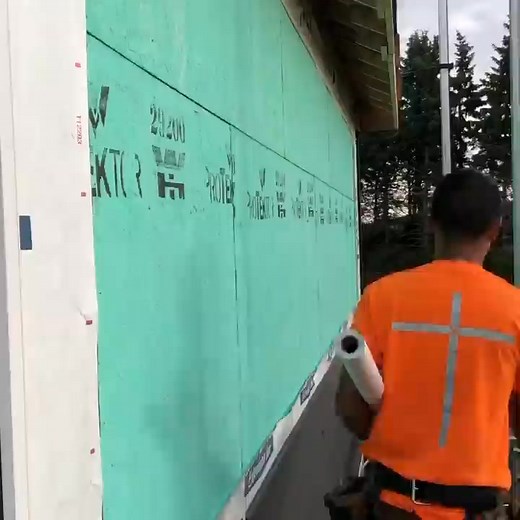 Rolling out building paper - this may seem like an easy task to most...