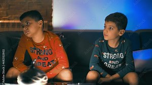 child watching a funny scene in front of a humorous film on TV at night