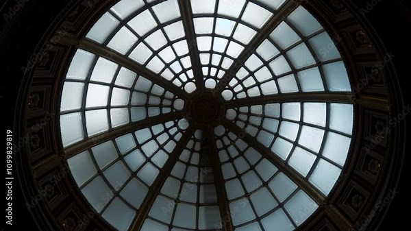 An intricate skylight design with geometric patterns enhances the rooms aesthetic appeal