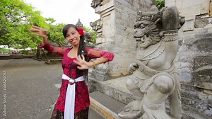 balinese girl dancing traditional dance in uluwatu temple, bali