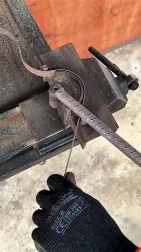 the process of bending an iron bar into a spiral shape manually