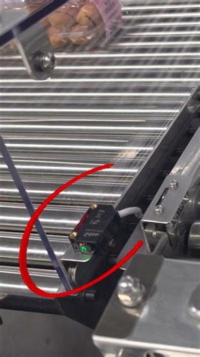 Tech sorting defective products at an eclair factory.