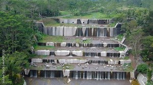 Aerial footage of the Watu Purbo sabo dam in Sleman, Indonesia which has a 6-level water dam. Apart from preventing the eruption of Mount Merapi, this dam is also a popular tourist destination