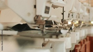 The automatic embroidery machine is working at high speed. Close-up