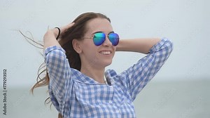 Cheerful asian woman barefoot walking on tropical summer beach. Woman walking along wave of sea water and sand on the beach. Enjoyment barefoot walk outdoor with freedom. Relaxation Travel Concept.