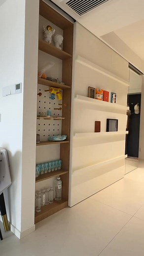 a sliding partition operates on a concealed top-hung track, allowing the panel to glide effortlessly without any floor rail. The result is a clean, uninterrupted surface and a refined way to reveal hidden storage while maintaining a seamless, modern look 💫💡✨ • • #slidingpartition #tracklessdoor | Tiffany Design Studio