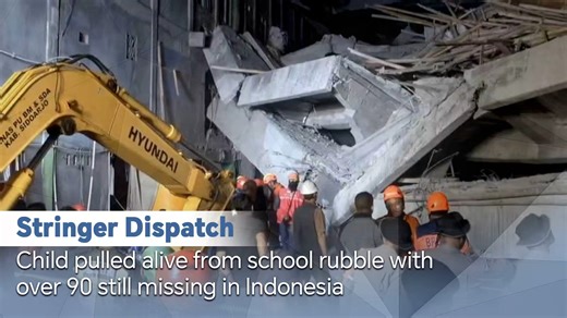 CGTN Stringer footage shows rescuers pulling a child out of a collapsed boarding school in Sidoarjo, East Java, Indonesia. Authorities said on October 1 that at least 91 students remained buried under rubble two days after the building caved in. Parents are anxiously waiting for news as rescue operations are ongoing. | CGTN