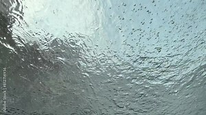 car wash. view from inside the automobile. close-up. washing car with clean water high pressure spray, car windshield cleaning. high pressure water spraying the window outside