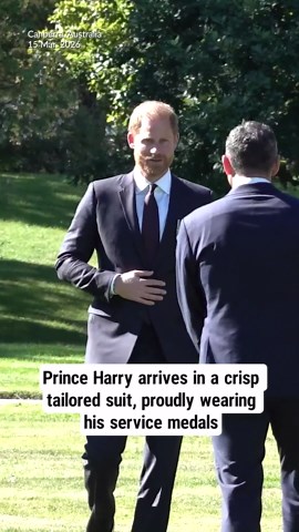 Prince Harry arrives in a crisp tailored suit, proudly wearing his service medals