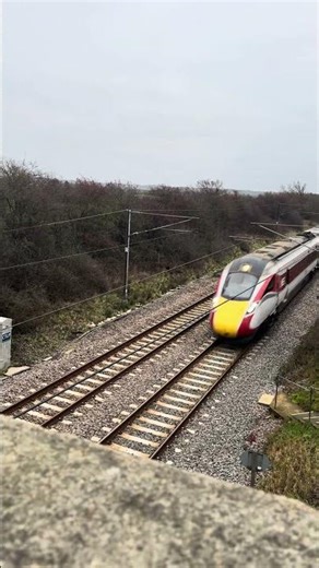 LNER Class 801 “Azuma” passes under a bridge at high speed