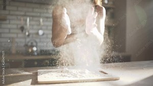 Professional female cook in lingerie claps her hands and powder flies. Ingredients and preparation stages. Slowmotion shot.