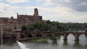 View of Albi, characteristic French town with Sainte-Cécile cathedral and old bridge on river Tarn. Town as travel destination in Tarn department, Occitanie region, southern France, Europe