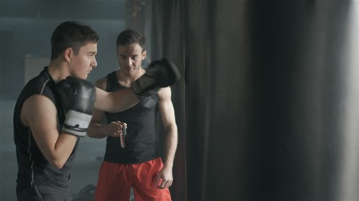 Personal trainer take time in a boxing training   - Free Stock Video