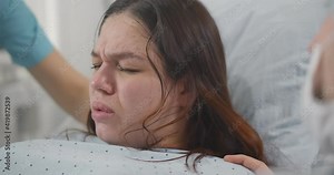 Close up of pregnant woman giving birth to baby in hospital